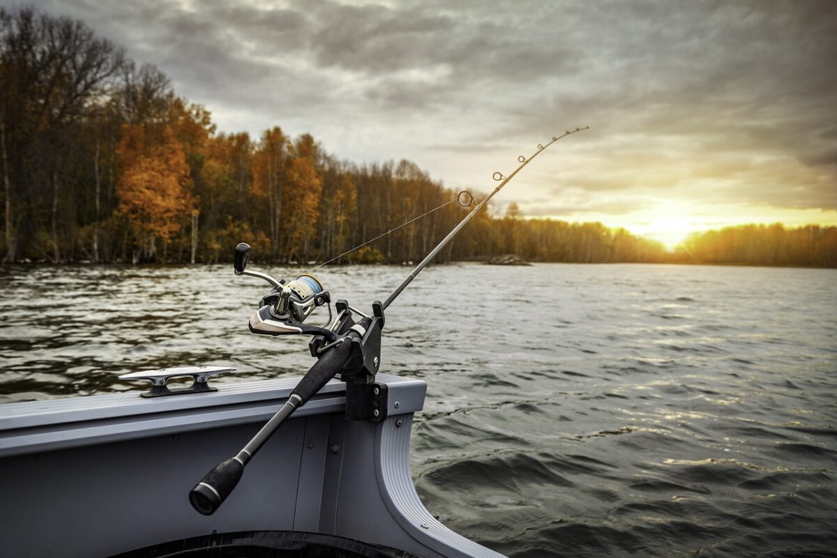 A Guide to Fly Fishing in Kenya 3 Fly fishing rod on the edge of a boat on an autumnal lake